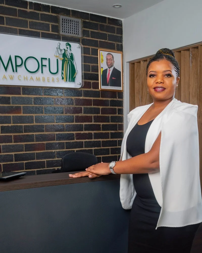 Cecilia Gwenzi, Receptionist and Administrator, at the front desk